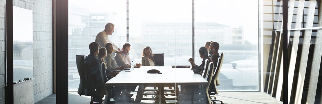 Business owner and employees meet in a modern conference room to discuss corporate philanthropy and how a donor-advised fund can streamline and enhance their charitable giving strategy.